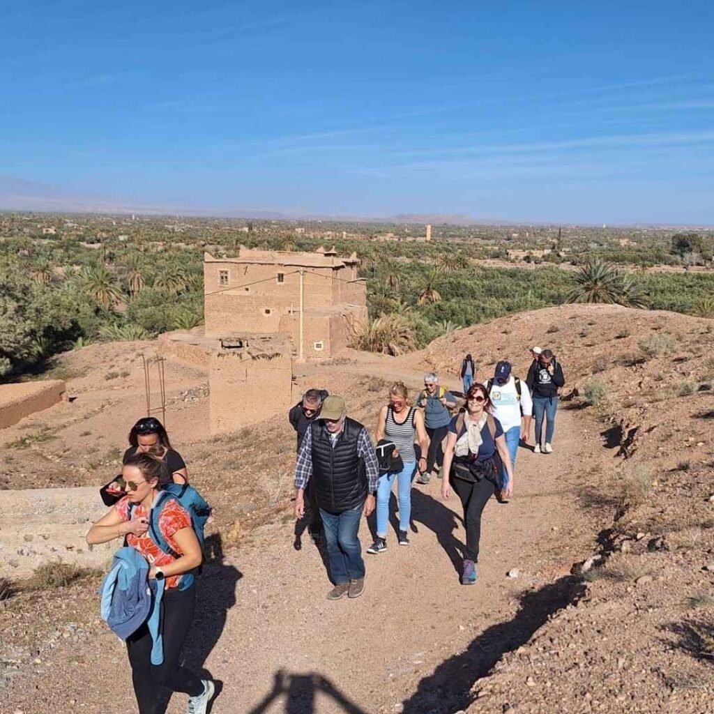Travelers hiking through a scenic Berber village valley on the 5 Days Tour from Casablanca
