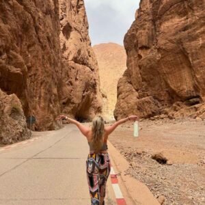 Traveler exploring the towering rock walls of Todra Gorge on a 5 Days Tour from Marrakech to Fes.